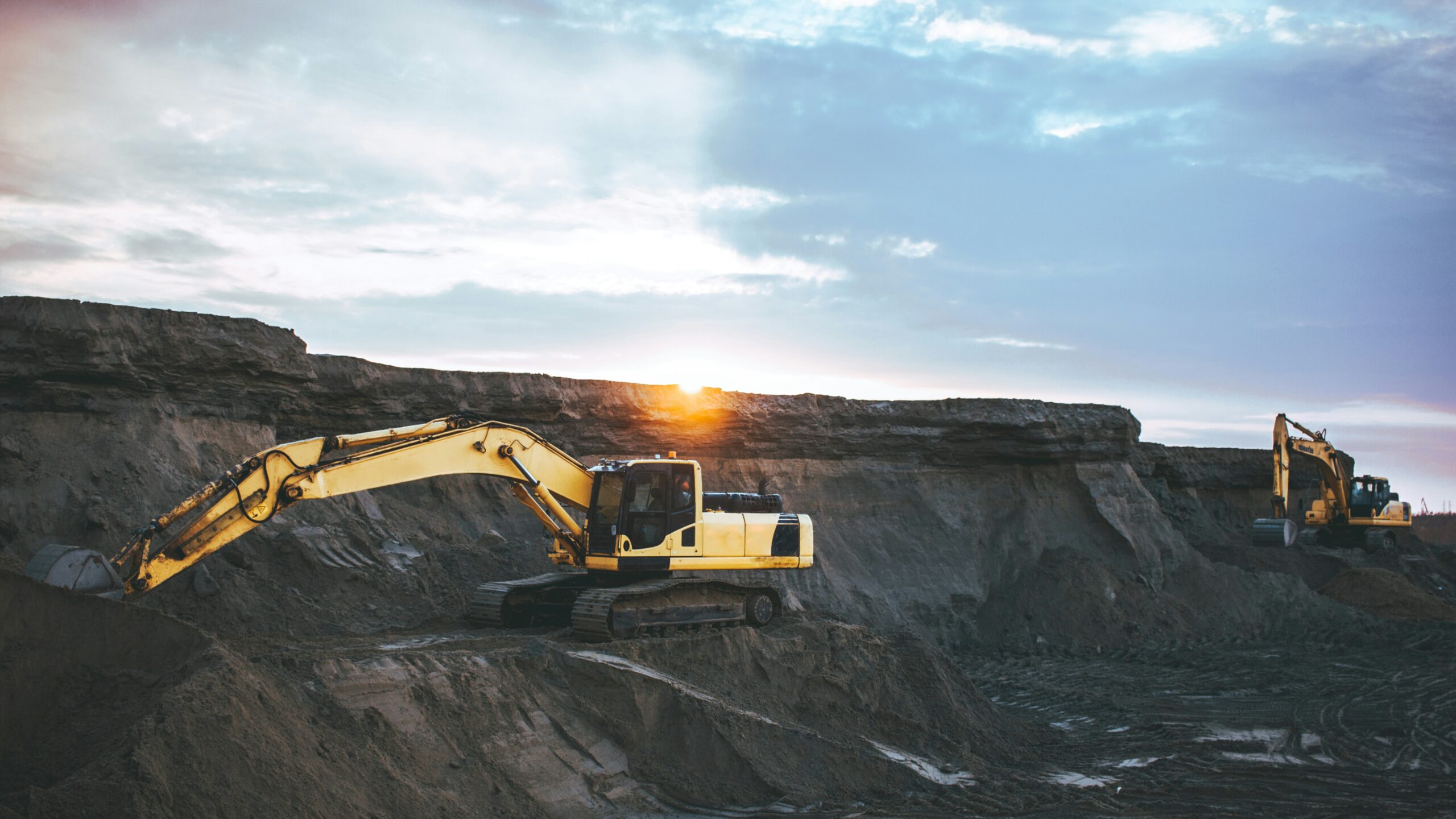 Excavators at work in an open coal mine during sunset – representing India’s coal industry linked to the Coalgate scam.