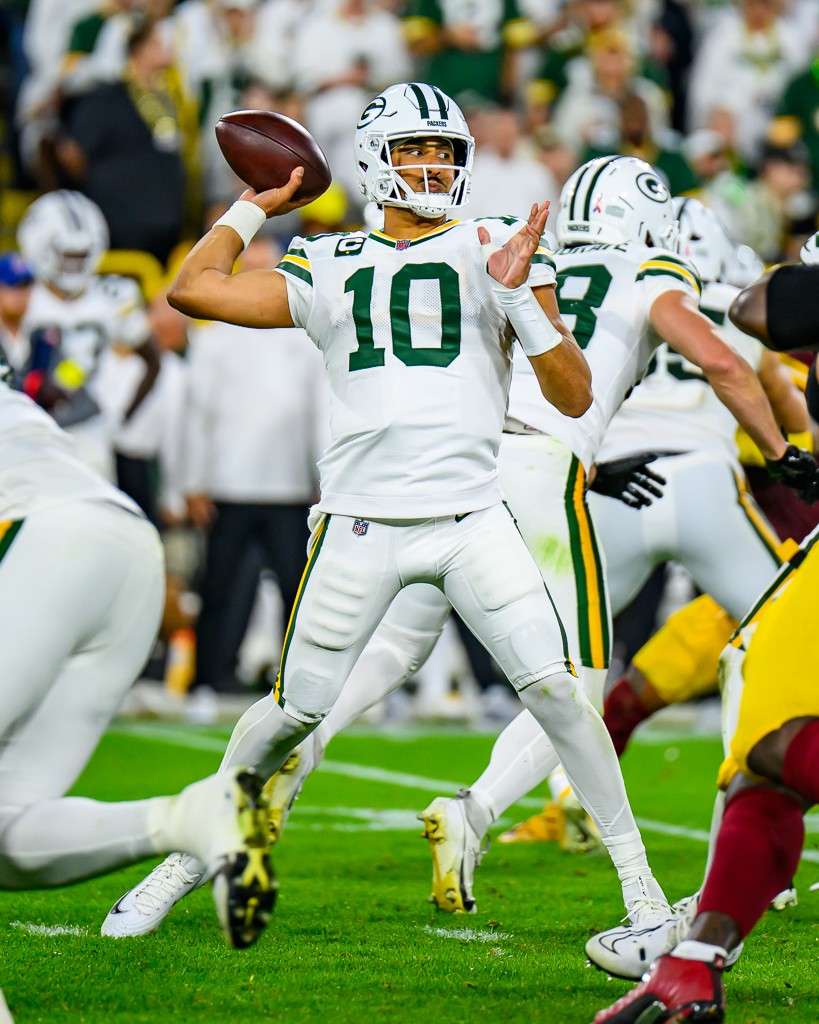 Jordan Love of the Green Bay Packers drops back to pass against the Washington Commanders at Lambeau Field during the 2025 NFL season
