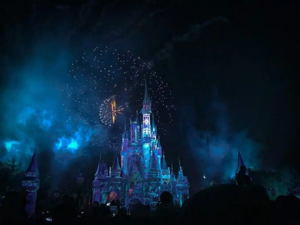 Fireworks lighting up a castle at night, representing magical entertainment and streaming experiences ideal for Disney plus