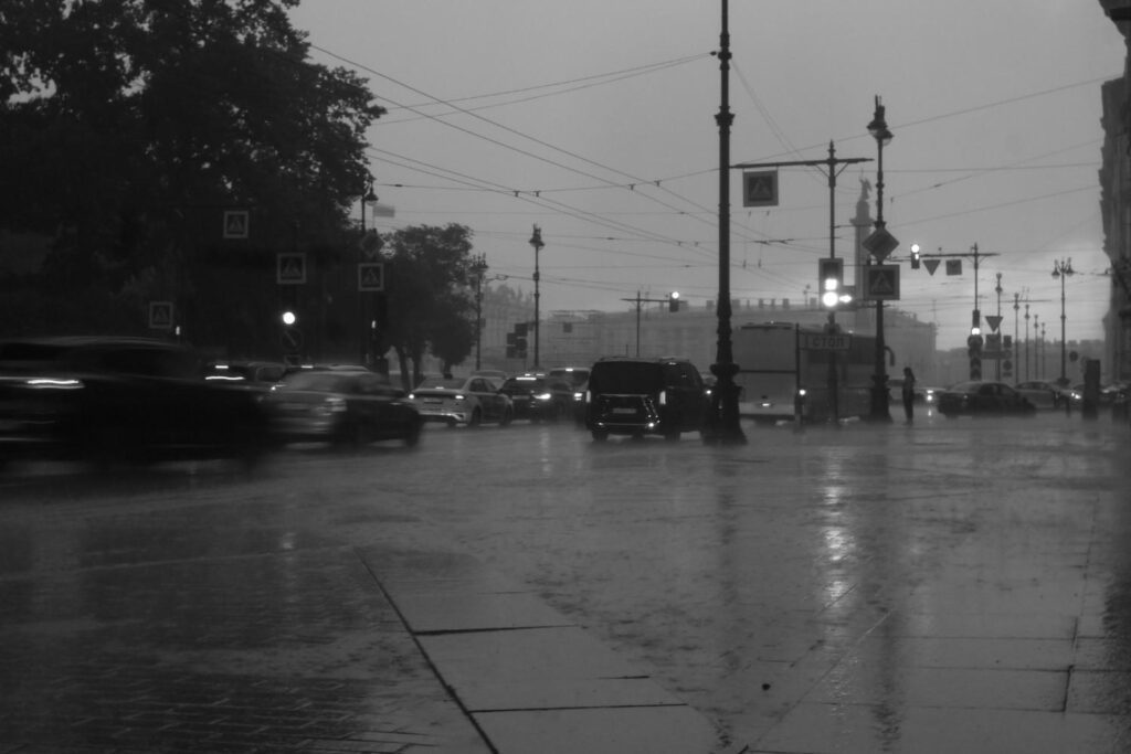Black-and-white city street during heavy rain as the Pineapple Express storm brings intense rainfall and flooding risk to urban California.