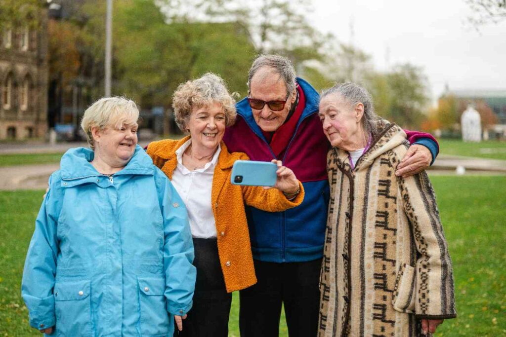 Four smiling seniors taking a selfie outdoors, representing extra IRS tax deductions for seniors under the One Big Beautiful Bill Act (OBBBA)