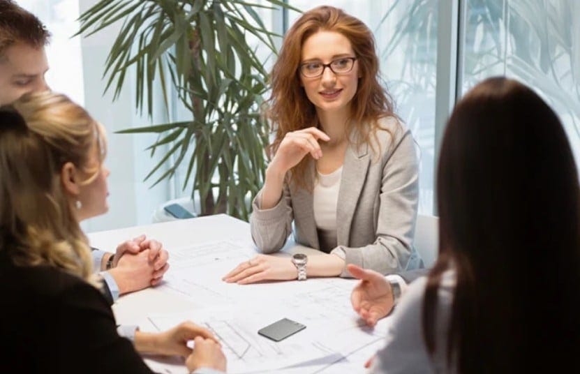 Plaud Note AI device recording a business meeting conversation on table