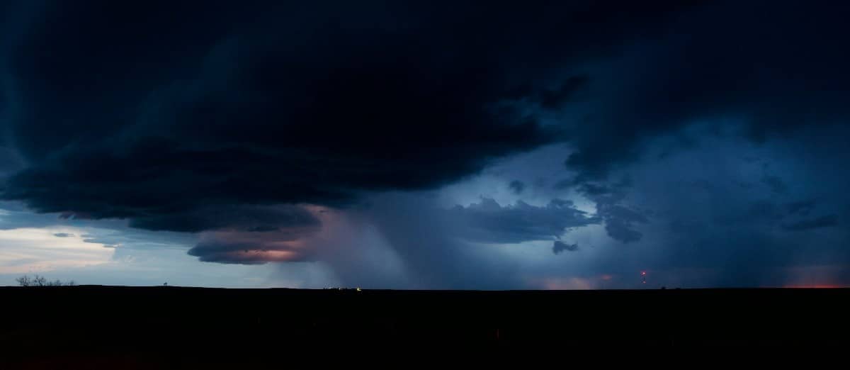 Dark storm clouds spreading across landscape indicating severe weather conditions